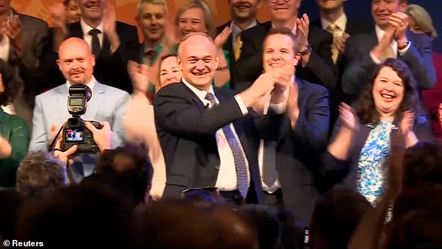 Curling moment Ed Davey sings Abba's 'Take A Chance on Me' during Lib Dem conference speech - as he reveals he wanted to be filmed 'putting his hand behind a cow' in a bid to get more votes elections